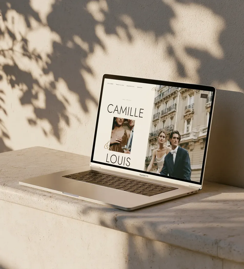 Lumière wedding website shown on a laptop on a sunlit stone ledge