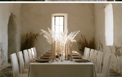 Wedding table set with dried grasses beneath tall windows