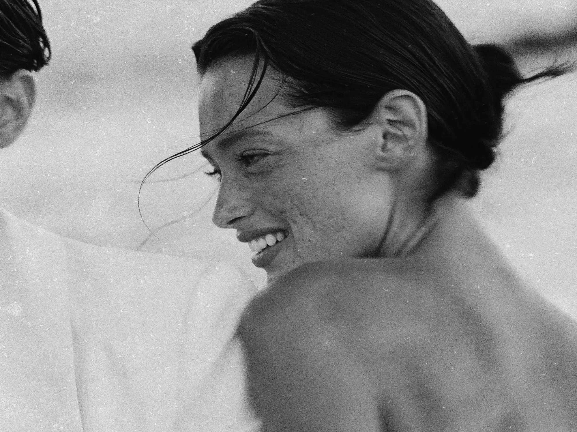 Black and white portrait of the bride laughing