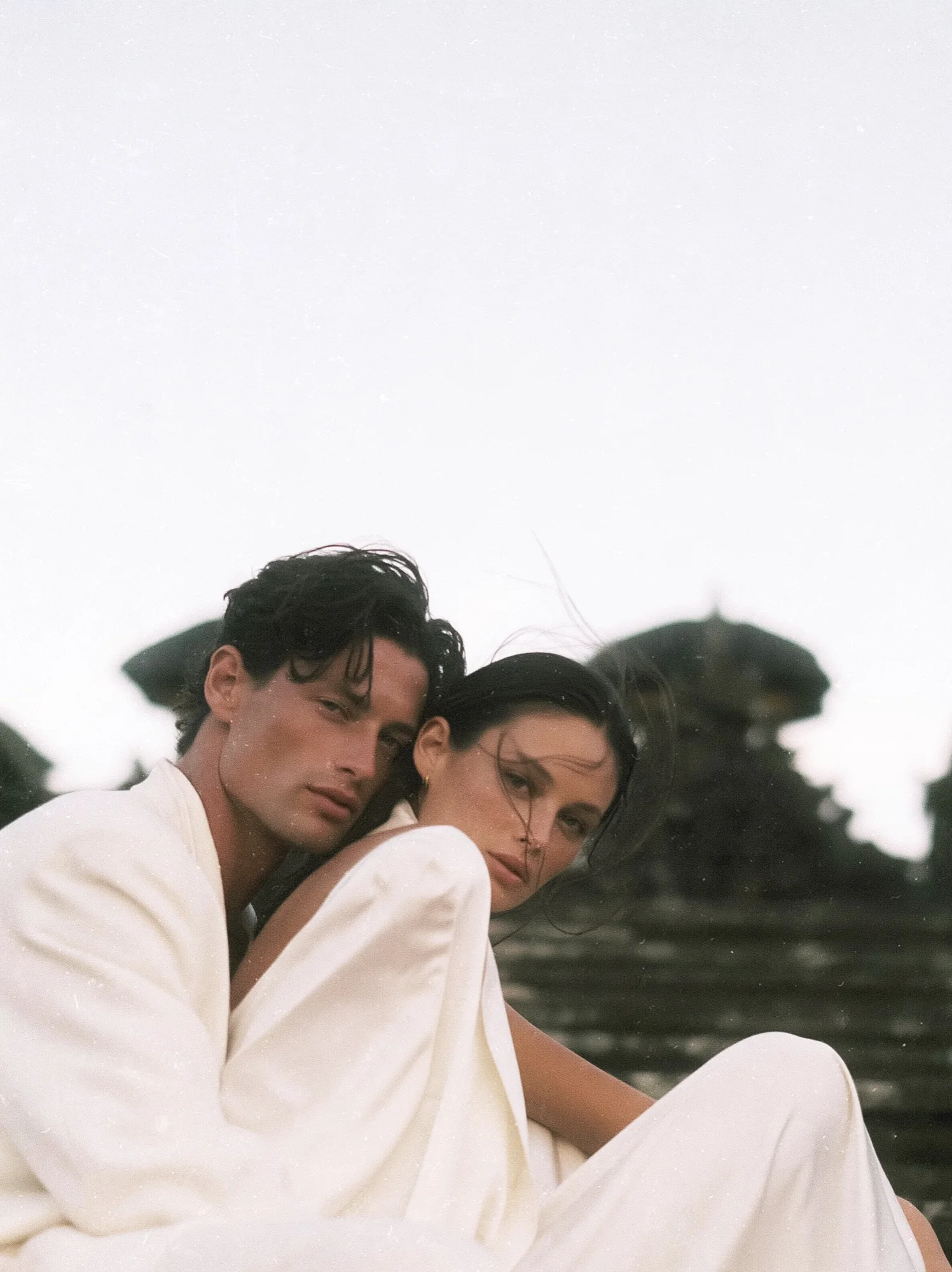 Couple wrapped in white linen at a Balinese temple