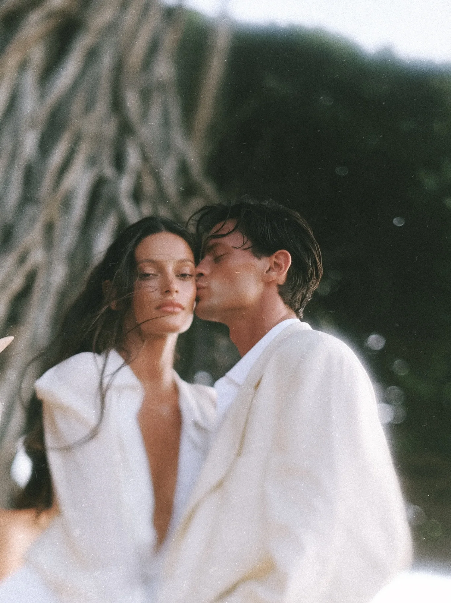 Couple embracing under tropical palms