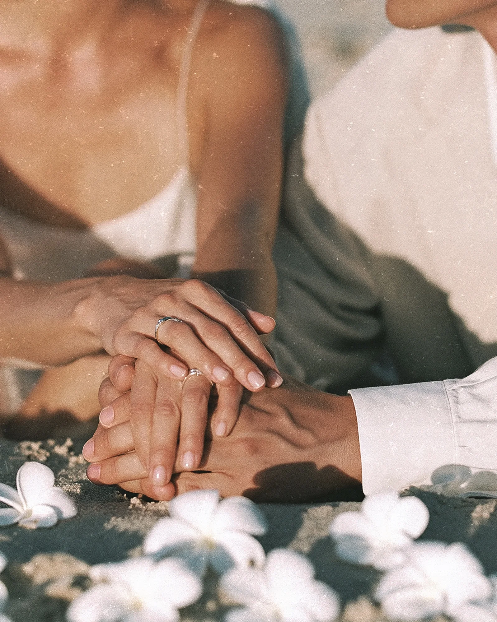 Close-up of the couple holding hands
