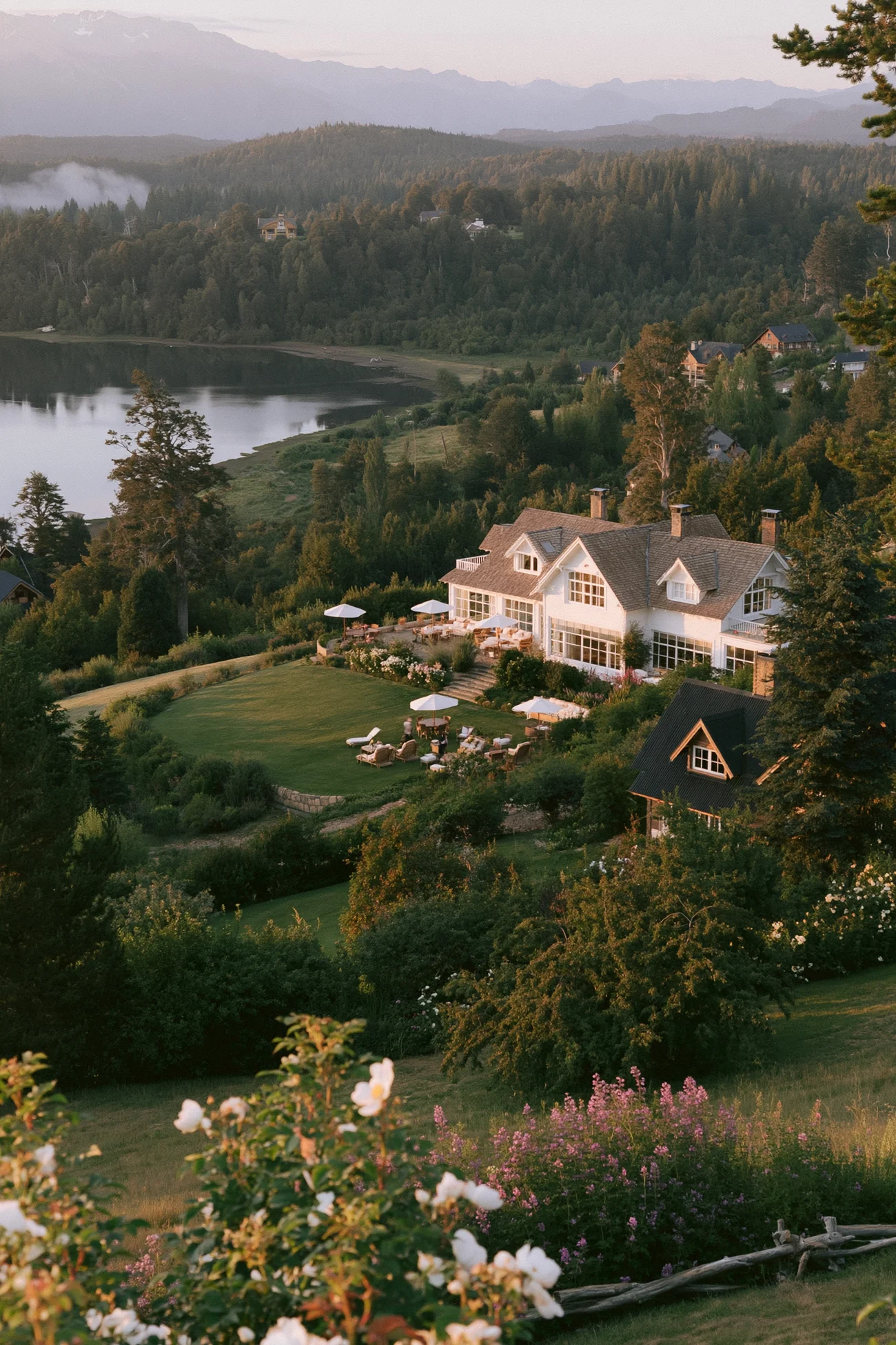 Mountain lodge among green hills above a lake in Patagonia