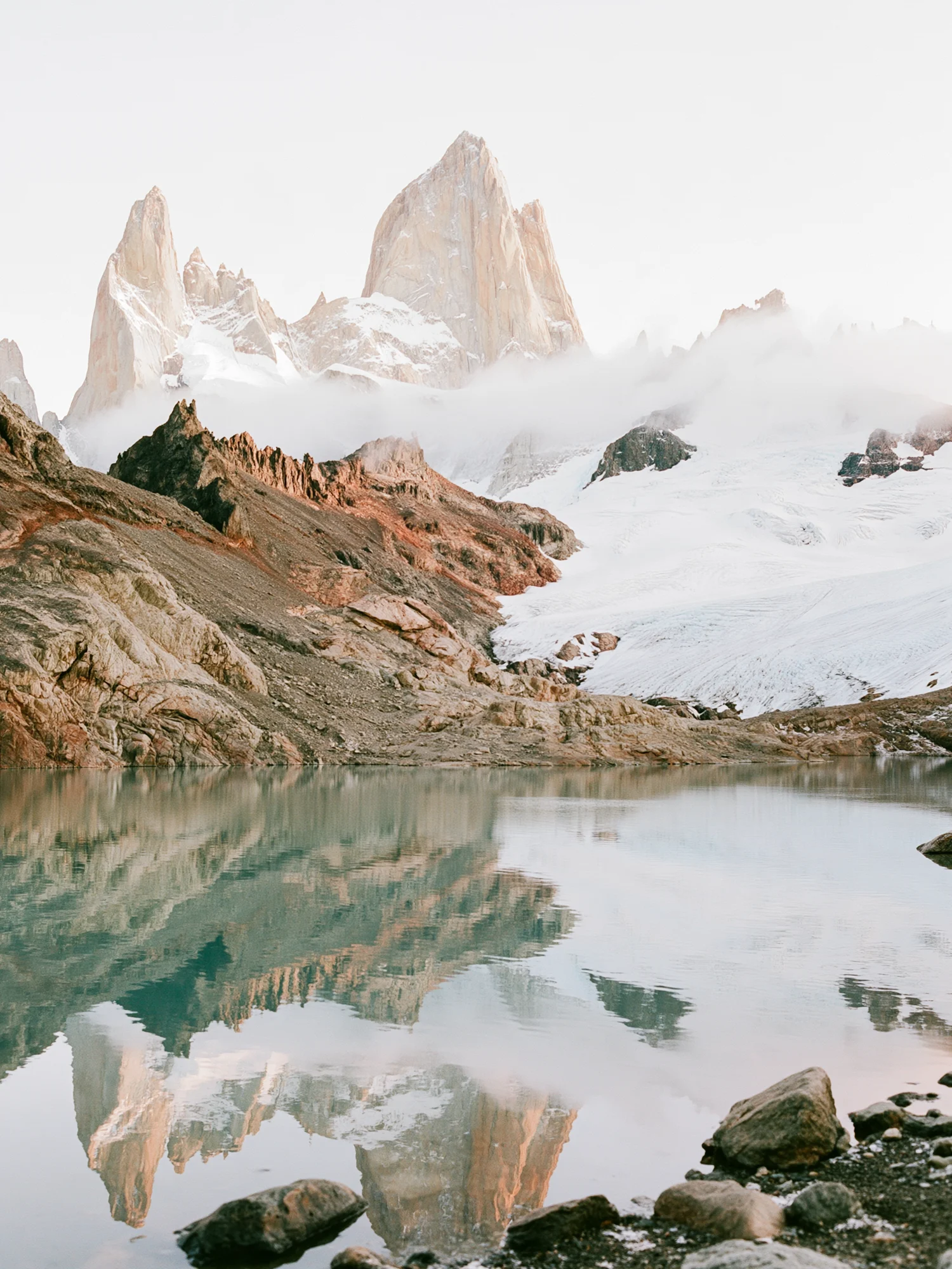 Fitz Roy granite peaks reflected in a still mountain lagoon