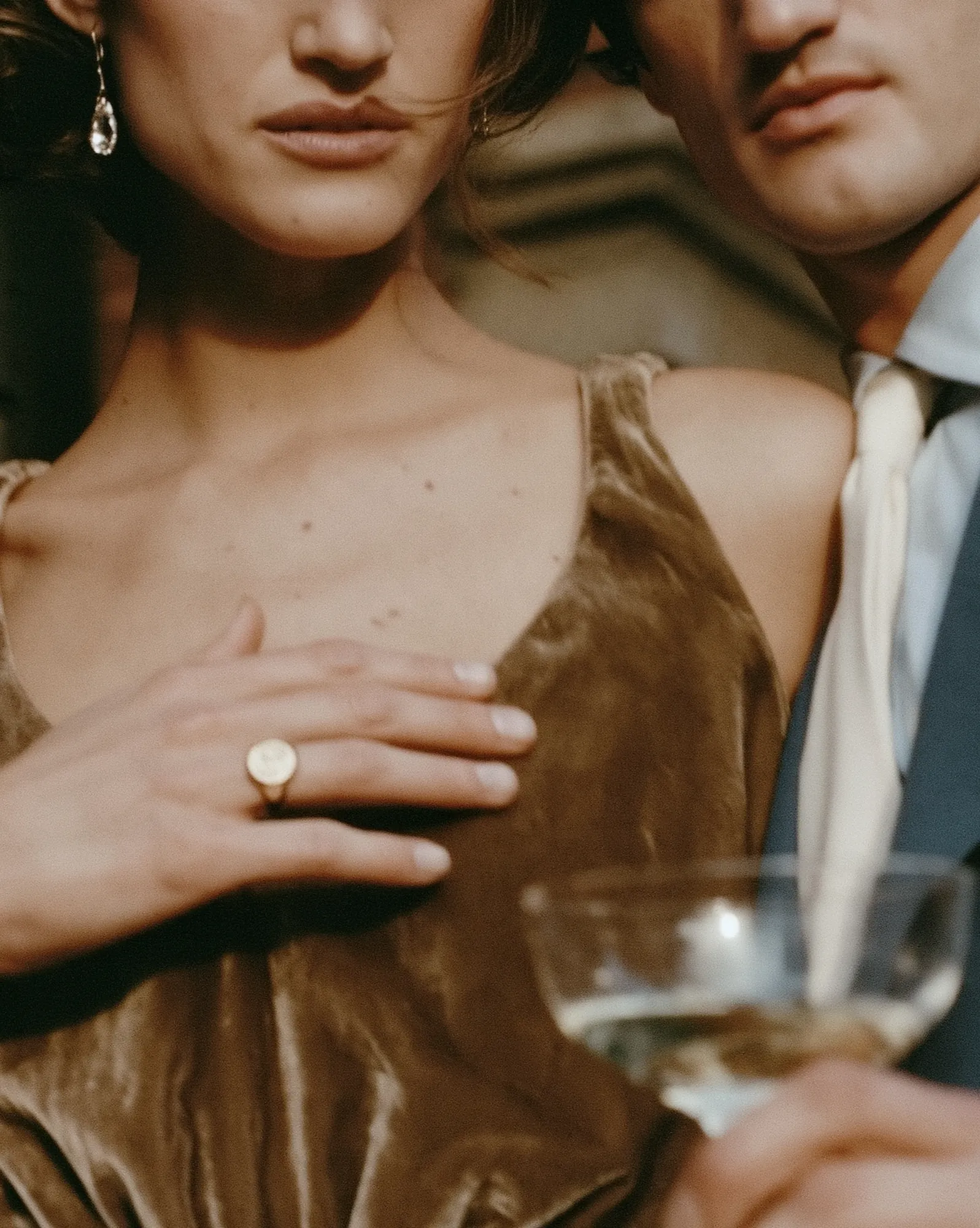 Close-up of the couple with champagne and an engagement ring