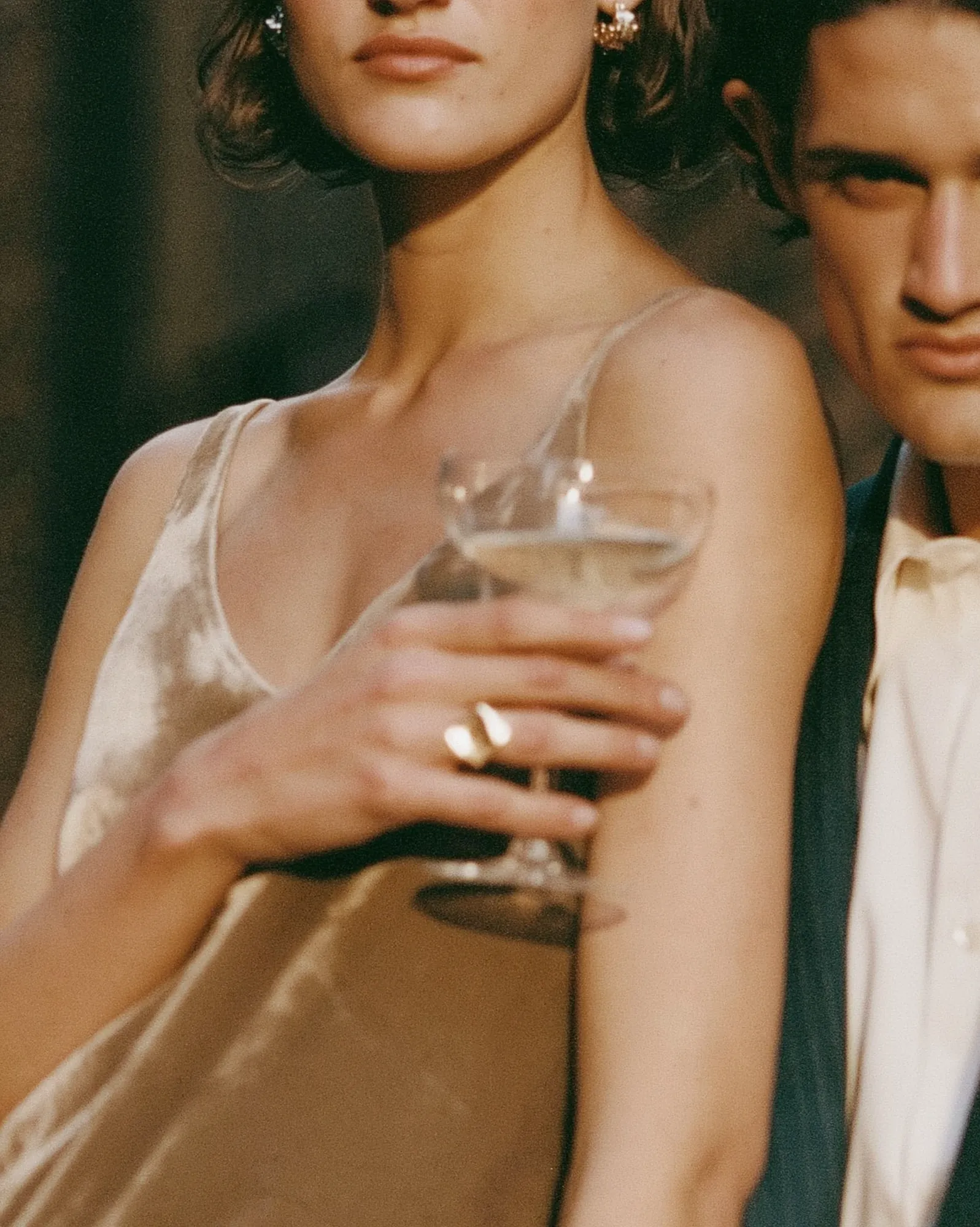 Bride holding a champagne glass with her engagement ring