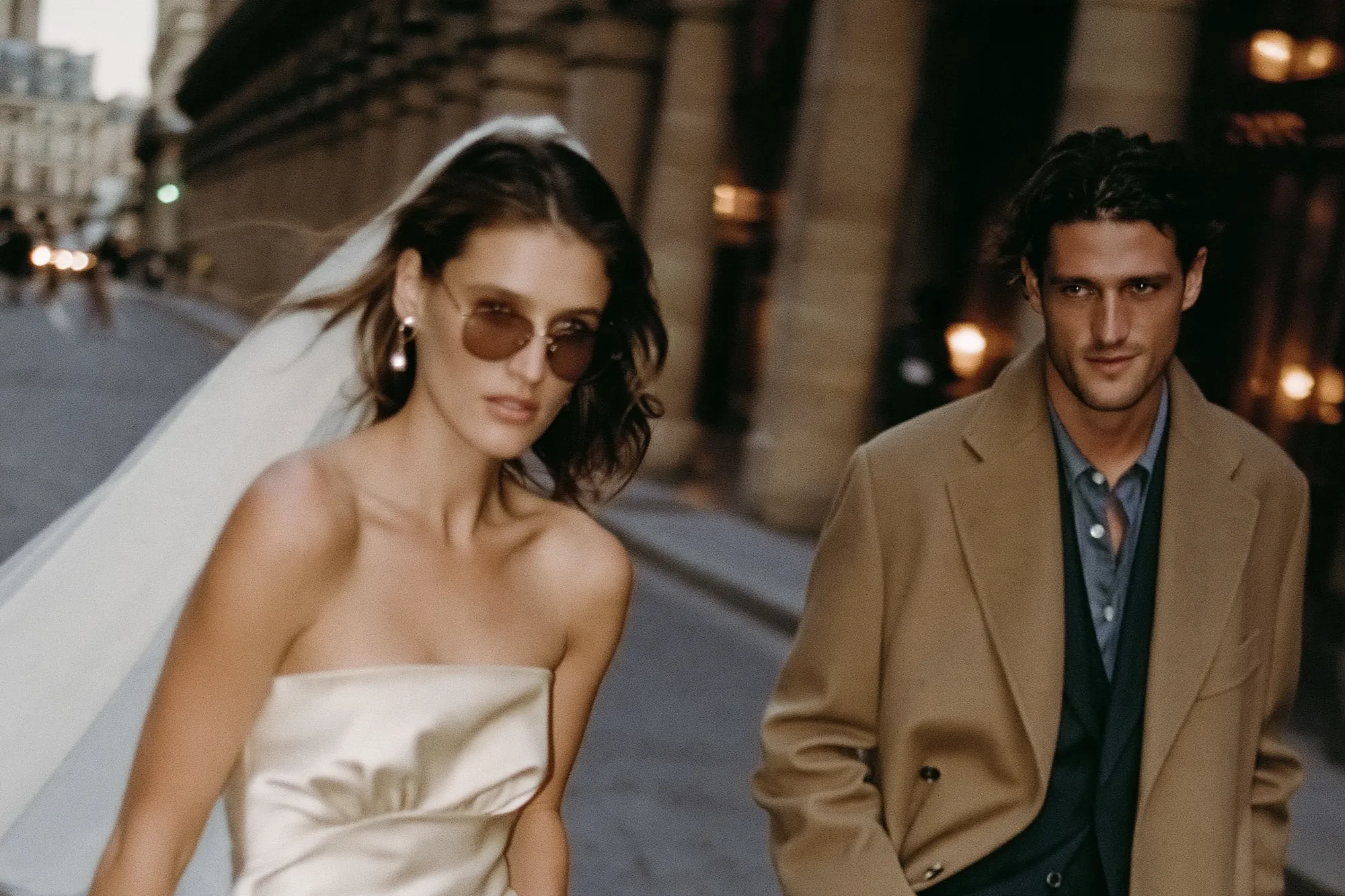 Bride with a long veil walking through Paris with the groom