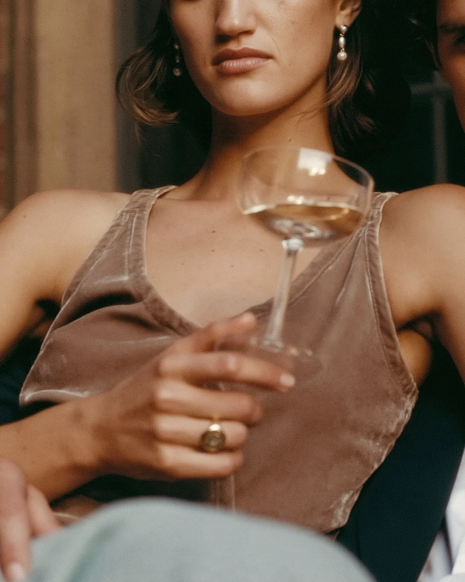Close-up of an engagement ring and champagne