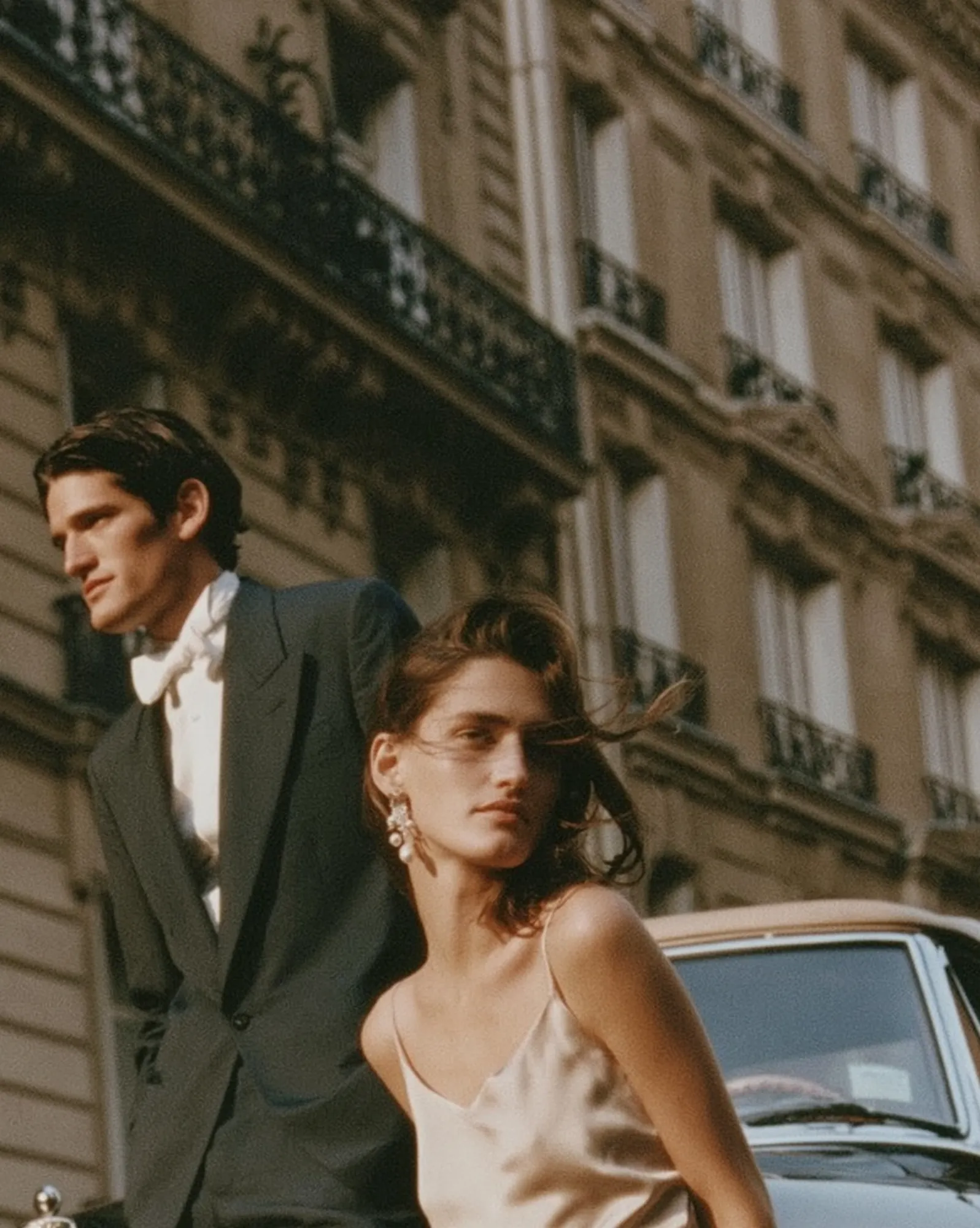 Bride and groom with a vintage convertible in Paris