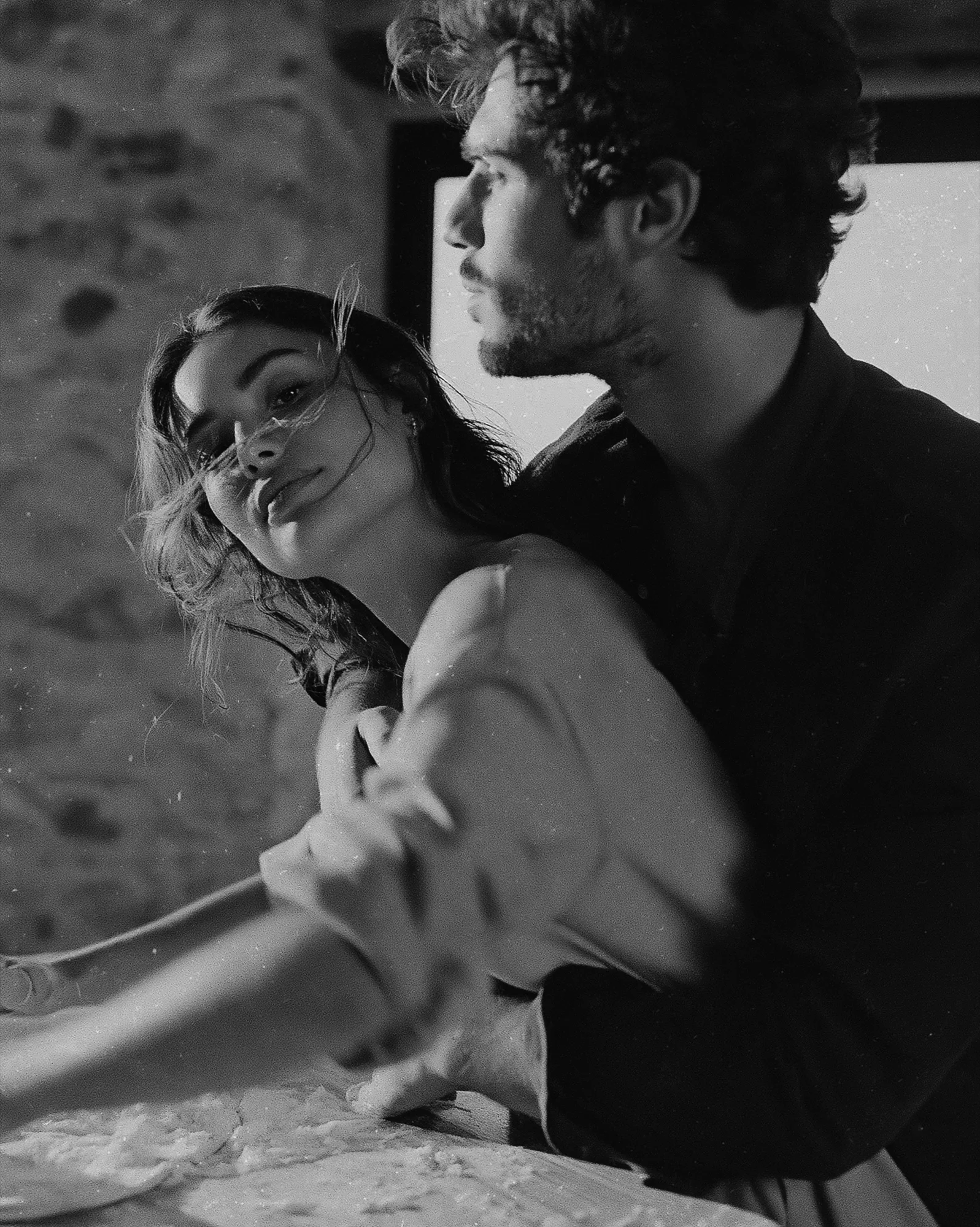Black and white candid portrait of the couple laughing together