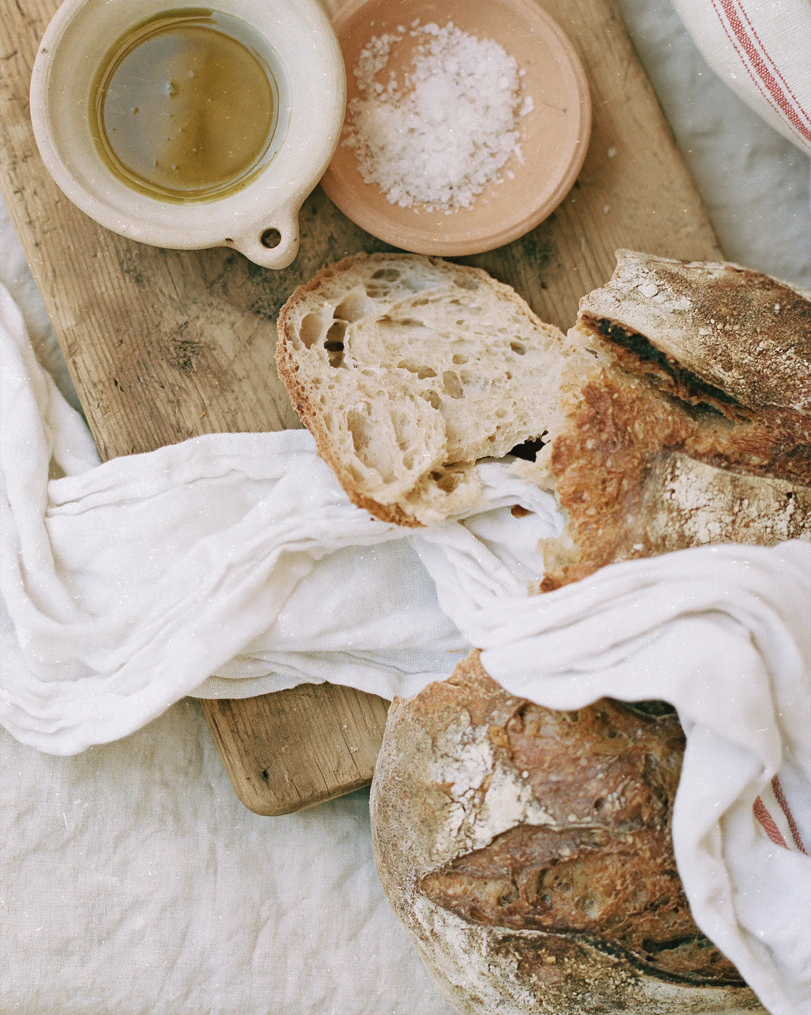 Rustic bread, olive oil and sea salt on a wooden board